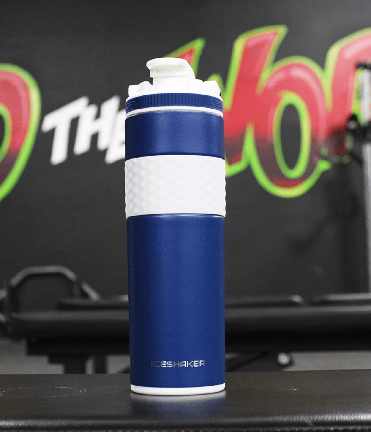 An image of the Navy 20oz Skinny Shaker in a gym setting.